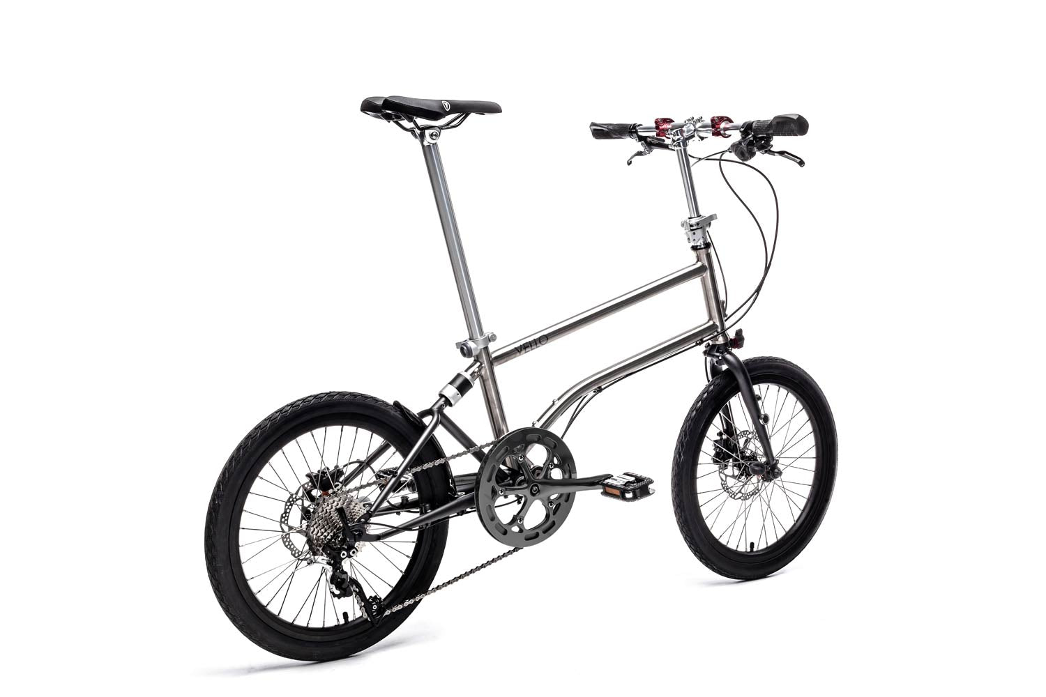 Ein entfaltetes VELLO Rocky Titan Faltrad / Klapprad in der Farbe gebürstetes Titan, mit 20 Zoll Schwalbe Kojak Reifen, der Fokus sitzt auf dem Hinterrad Shimano Deore XT 10-Gang Schaltwerk.
